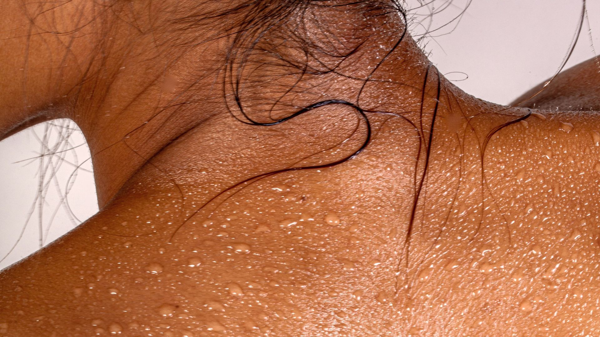 Woman with rejuvenated skin, sweating from infrared sauna therapy