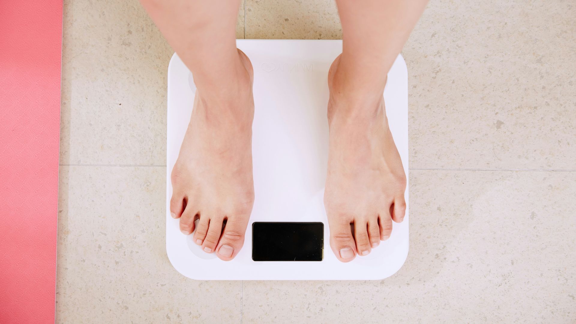 Feet standing on scale after infrared sauna session to reduce water retention