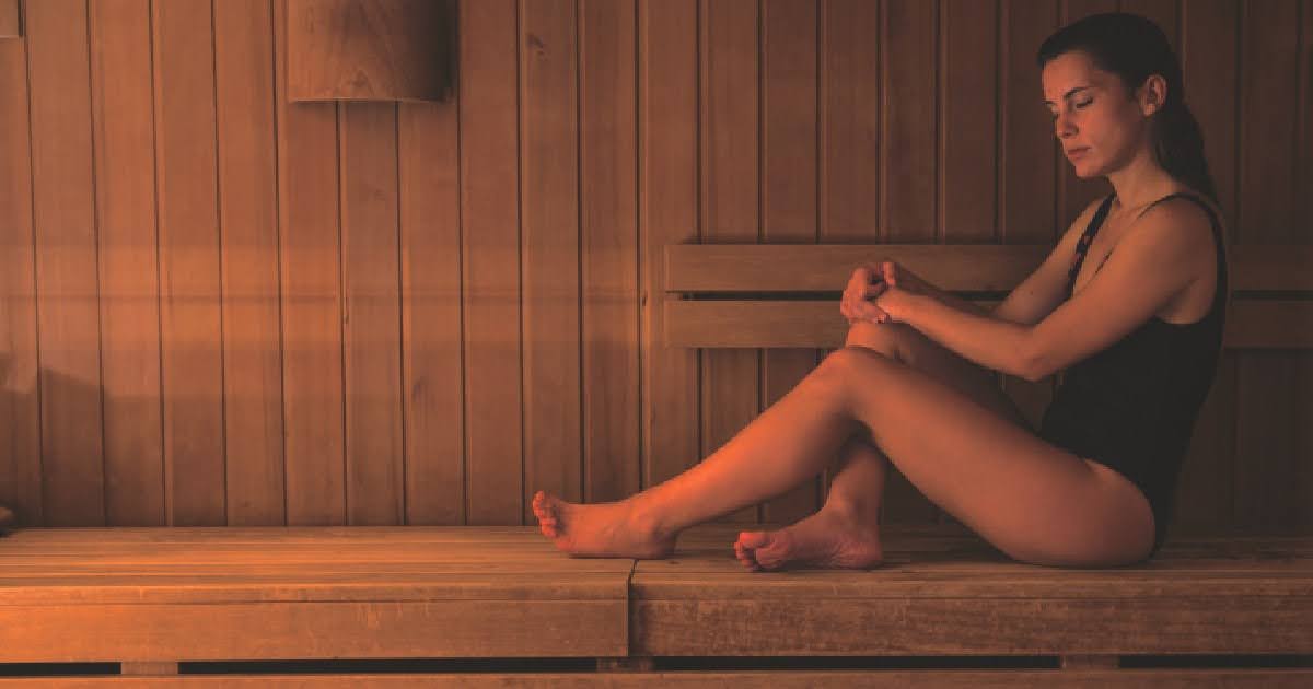 Woman in infrared sauna, improving her digestive health
