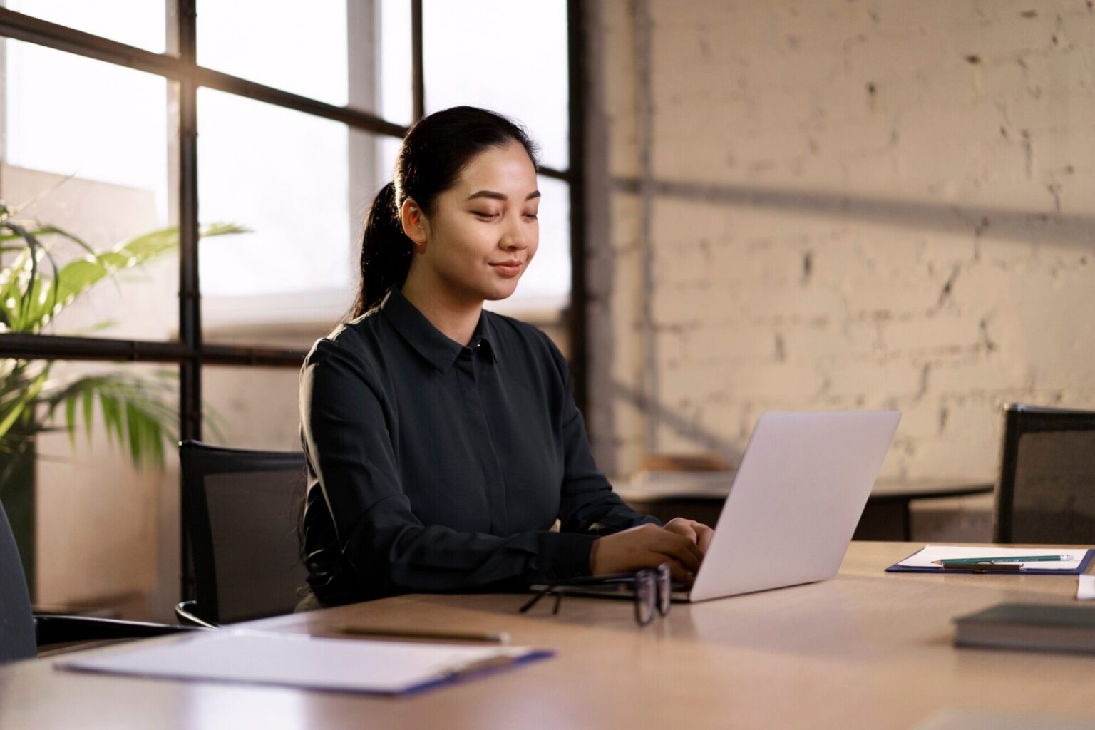 Woman at desk enjoys productivity boost after infrared sauna session